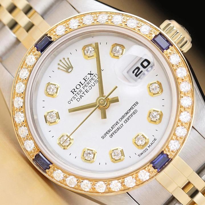ROLEX LADIES DATEJUST 79173 WHITE DIAL 18K GOLD STEEL DIAMOND SAPPHIRE WATCH: This is an authentic Rolex Datejust 79173 no holes watch with Rolex 18K yellow gold and stainless steel jubilee bracelet, Rolex dial Ref. with added genuine diamond markers, and custom 18K yellow