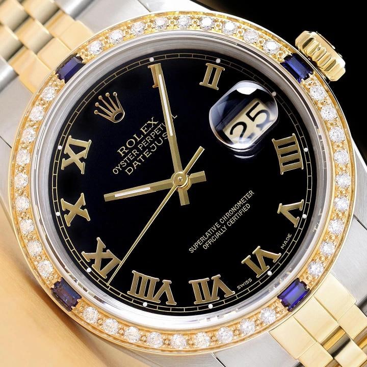 ROLEX MENS DATEJUST 16013 BLACK ROMAN DIAL SAPPHIRE DIAMOND 18K GOLD STEEL WATCH: This is an authentic Rolex Datejust 16013 watch with Rolex two tone 18K yellow gold and stainless steel jubilee bracelet, Rolex dial Ref. with added roman hour markers, and custom 18K yellow gold