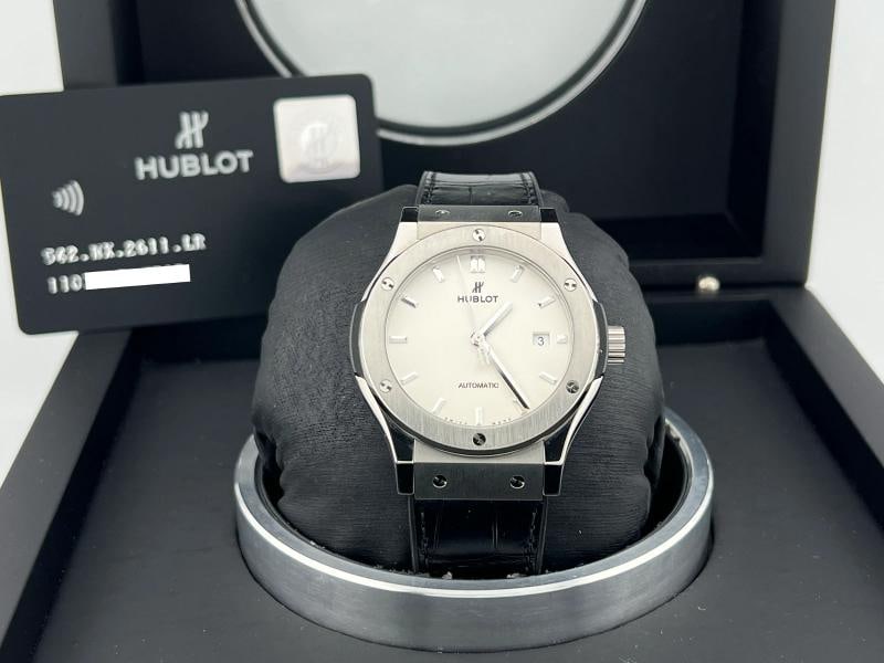 Hublot Classic Fusion 542.NX.2611.LR 42mm White Opaline Dial Titanium Box Paper: Condition: Pre-owned - Excellent,Country of Origin: Switzerland,Bezel Color: Silver,Closure: Deployant,Year Manufactured: 2010-2019,Band/Strap: Two-Piece Strap,Case Color: Silver,Department: