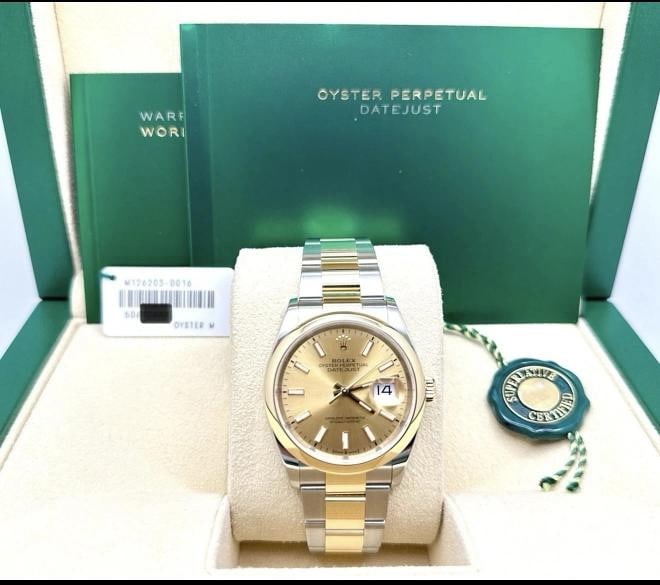Rolex Datejust 126203 36mm Champagne Dial 18K Yellow Gold Steel Box Booklets: Style Number: 126203 Year: 2020 - 2026 Model: Rolex Datejust 36 Case Material: Stainless Steel Band: 18K Yellow Gold & Stainless Steel Bezel: 18K Yellow Gold Dial: Champagne Crystal: Sapphire Case