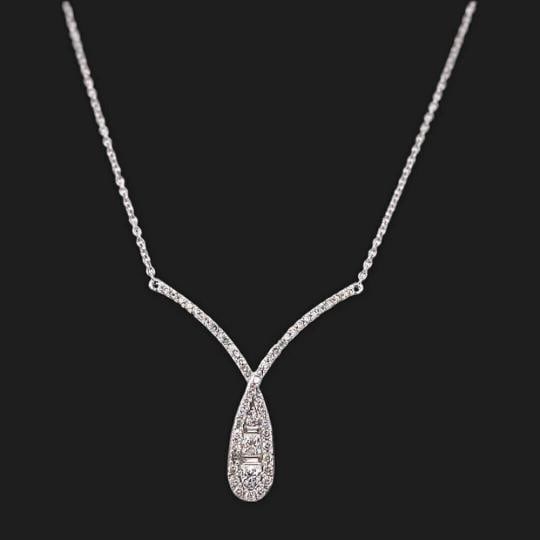 Ladies Round & Baguette Diamond Crossover Necklace 14kt White Gold: Condition: Pre-owned - Excellent,Pendant Shape: Cross,Main Stone Creation: Natural,Fancy Diamond Color: White,Length (inches): 16' - 18',Color: White,Main Stone Color: White/Colorless,Metal: White