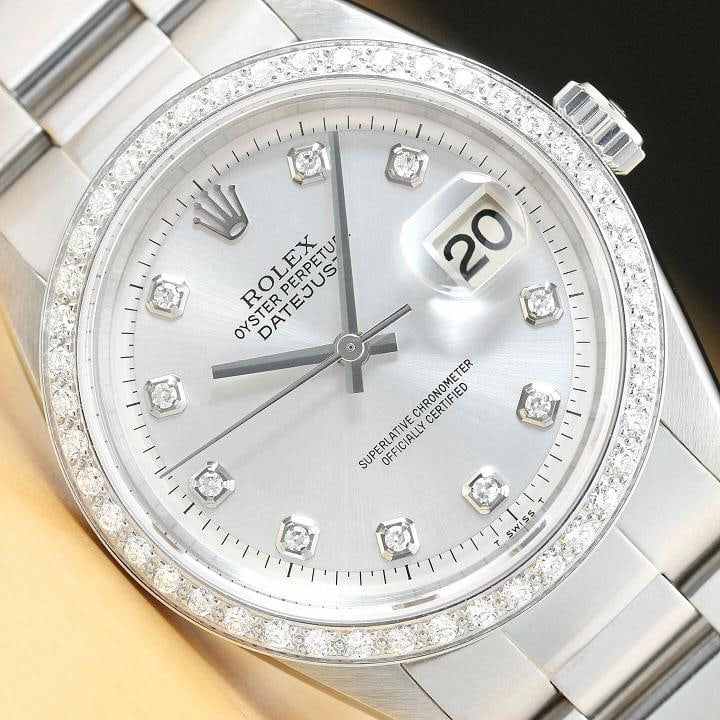MENS ROLEX DATEJUST SILVER DIAMOND 18K WHITE GOLD BEZEL & STAINLESS STEEL WATCH: This is an authentic Rolex Datejust 1603 watch with Rolex dial Ref. with added diamond hour markers, custom 18K white gold diamond bezel, and custom stainless steel oyster bracelet. Descriptions: Bran