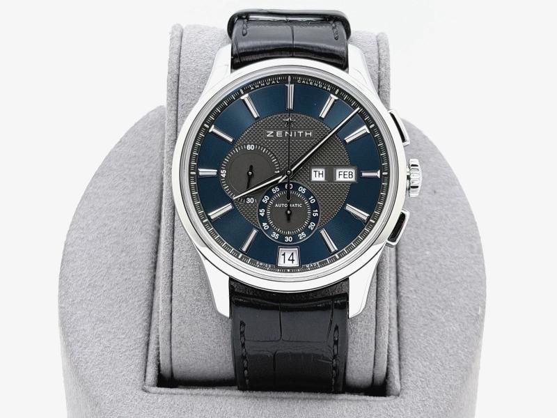 Zenith El Primero Winsor Annual Calendar 03.2070.4054 42mm Blue Dial Steel: Style Number: 03.2070.4054 Model: Zenith El Primero Winsor Annual Calendar Case Material: Stainless Steel Band: Black Leather Bezel: Stainless Steel Dial: Blue Crystal: Sapphire Case Size: 42mm Includ