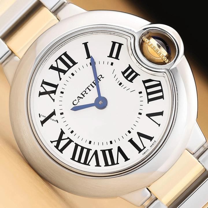CARTIER LADIES BALLON BLEU W69007Z3 28MM ROMAN 18K YELLOW GOLD STEEL WATCH: This is an authentic Cartier Ballon Bleu W69007Z3 watch with silver dial and roman numeral hour markersÃ¢â‚¬â€¹, stainless steel smooth bezel, stainless steel