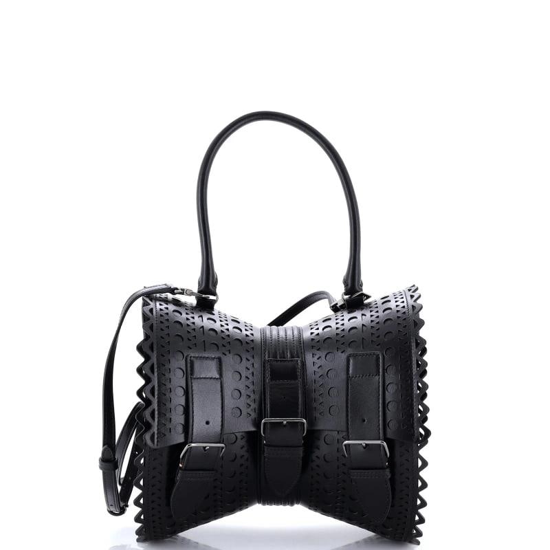 Alaia Edition 1992 Corset Bag Laser Cut Leather 18: Accessories: With Strap Measurements: Handle Drop 6.5", Height 6.5", Width 8.5", Depth 4", Strap Drop 21.5-23.5". Condition: Pre-owned - Good,Brand: Alaia,Exterior Material: Leather,Style: Top Handle,