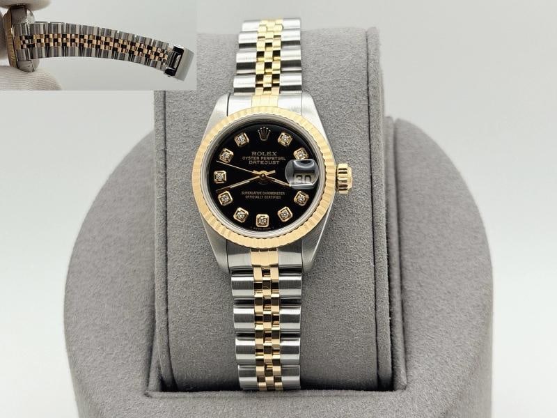 Rolex Lady Datejust 69173 26mm Black Diamond Dial 18k Yellow Gold Steel: Style Number: 69173 Serial: E45**** Year: 1990 Model: Rolex Ladies Datejust Case Material: Stainless Steel Band: 18k Yellow Gold & Stainless Steel Jubilee Bezel: 18k Yellow Gold Fluted Dial: Custom Bl