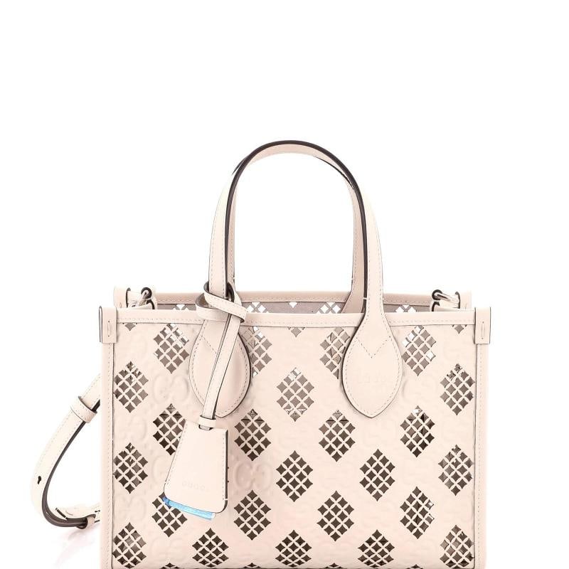 Gucci Convertible Tote GG Debossed Laser Cut Leather Small: Accessories: Clochette, Pochette, With Strap Measurements: Handle Drop 6", Height 8.5", Width 11", Depth 4", Strap Drop 24". Condition: Pre-owned - Excellent,Brand: Gucci,Exterior Material: Leather,St
