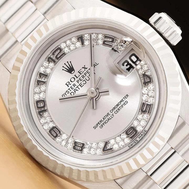 ROLEX DATEJUST 69179 FACTORY SILVER MYRIAD ARABIC DIAMOND 18K WHITE GOLD WATCH: This is an authentic Rolex Lady Datejust 69179 watch with an Rolex 18K white gold president band, factory Rolex myriad arabic diamond dial, and Rolex 18K white gold fluted bezel.Descriptions: Brand: R