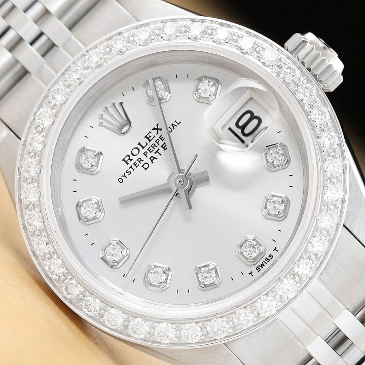 LADIES ROLEX DIAMOND DATE 6917 18K WHITE GOLD STAINLESS STEEL SILVER DIAL WATCH: This is an authentic Rolex Datejust 6917 watch with Rolex dial Ref. with added genuine diamond markers, custom 18K white gold diamond bezel, and custom stainless steel jubilee bracelet. Descriptions: 
