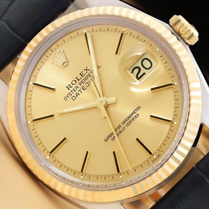 ROLEX MENS DATEJUST 1601 CHAMPAGNE DIAL14K GOLD STEEL BLUE LEATHER BAND WATCH: This is an authentic Rolex Datejust 1601 watch with Rolex stick dial Ref., Rolex 14K yellow gold fluted bezel, and custom genuine blue leather bracelet.Descriptions: Brand: Rolex Model: Datejust Refer