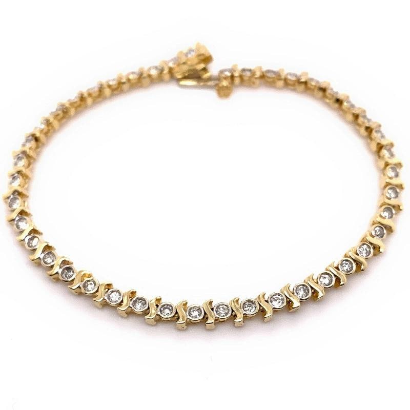 Round Brilliant Diamonds S Link 14kt Yellow Gold Tennis Bracelet: Metal: 14kt Yellow Gold Length: 6.75' Inches Weight: 9.42 grams Main Diamond: 43 Round Brilliant Cut Diamonds. Condition: Pre-owned - Excellent,Number of Diamonds: 43,Main Stone Creation:
