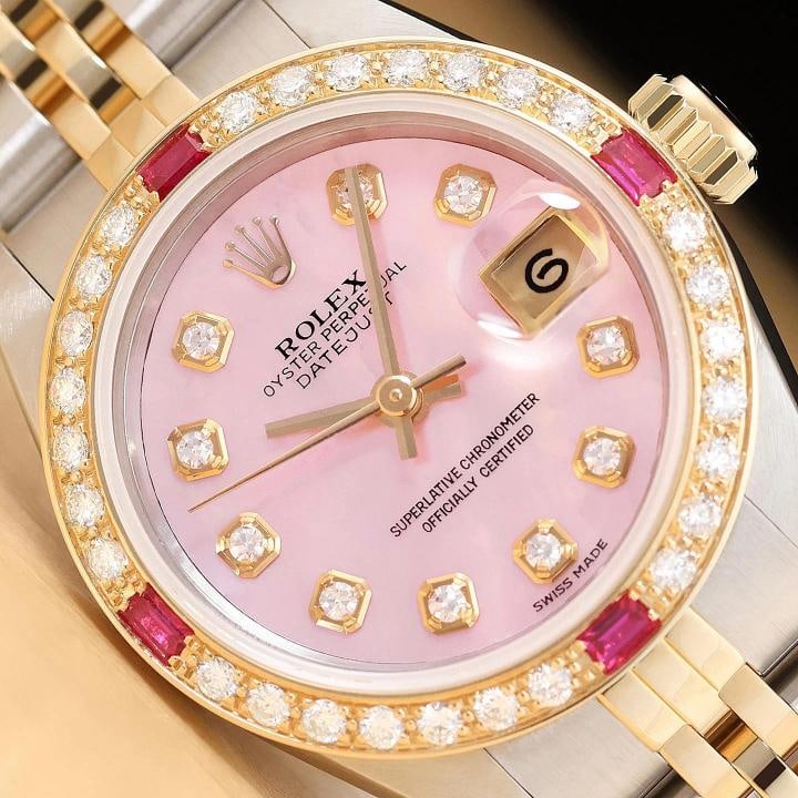 ROLEX LADIES DATEJUST 69173 PINK MOTHER OF PEARL 18K GOLD SS DIAMOND RUBY WATCH: This is an authentic Rolex Datejust 69173 watch with Rolex 18K yellow gold and stainless steel jubilee bracelet, Rolex dial Ref. with added genuine mother of pearl and diamond markers, and custom 18K 