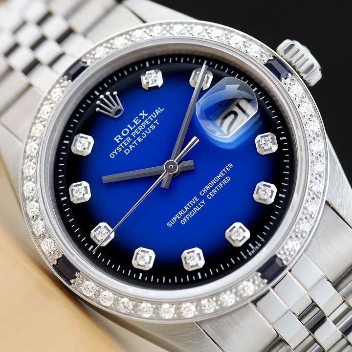MENS ROLEX DATEJUST BLUE VIGNETTE SAPPHIRE DIAMOND 18K WHITE GOLD & STEEL WATCH: This is an authentic Rolex Datejust 1603 watch with Rolex stainless steel jubilee bracelet, Rolex dial Ref. with added genuine diamond markers, and custom 18K white gold diamond and sapphire bezel. De