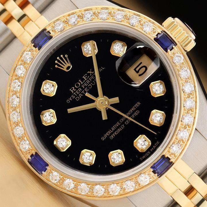 ROLEX LADIES DATEJUST 69173 BLACK SAPPHIRE DIAMOND 18K YELLOW GOLD STEEL WATCH: This is an authentic Rolex Datejust 69173 watch with Rolex 18k yellow gold and stainless steel jubilee bracelet, Rolex dial Ref. with added genuine diamond markers, and custom 18K yellow gold