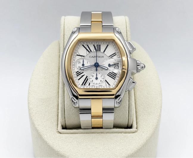 Cartier Roadster Chronograph XL 2618 W62027Z1 43mm Silver Dial 18K Gold Steel: Style Number: 2618 / W62027Z1 Year: 2002-2012 Model: Cartier Roadster Chronograph XL Case Material: Stainless Steel Band: 18k Yellow Gold and Stainless Steel Bezel: 18k Yellow Gold Dial: Silver Roman