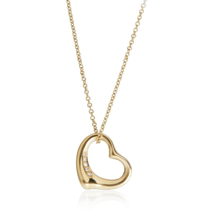 Tiffany & Co. Yellow Gold Diamond Elsa Peretti Open Heart Pendant: Condition: Pre-owned,Clasp/Buckle Type: Spring Ring,Side Stone Type: Diamond,Side Stone Weight (cts): 0.03,Metal Purity: 18k,With Original Box/Packaging: No,With Papers: No,Gross Weight (grams): 4.30,