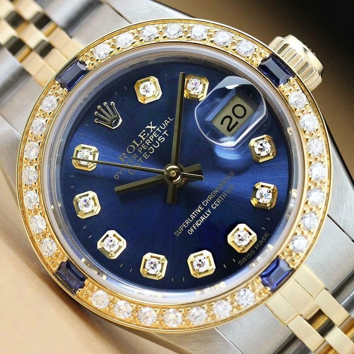 ROLEX LADIES DATEJUST 69173 BLUE 18K YELLOW GOLD STEEL DIAMOND SAPPHIRE WATCH: This is an authentic Rolex Datejust 69173 watch with Rolex 18K yellow gold stainless steel jubilee bracelet, Rolex dial Ref. with added genuine diamond markers, and custom 18K yellow gold sapphire