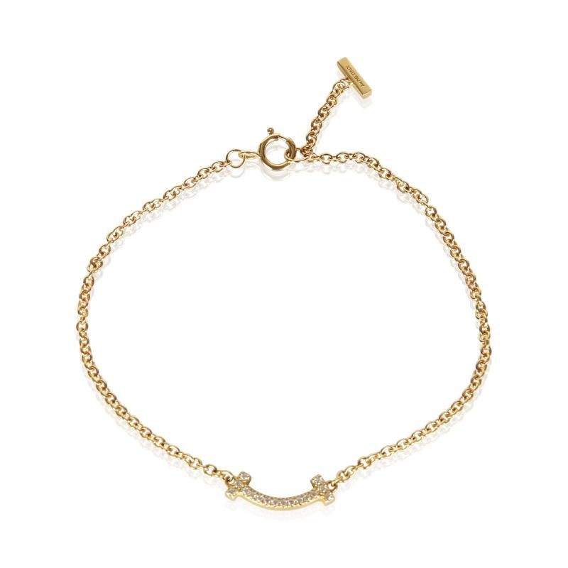 Tiffany & Co. Yellow Gold Diamond Tiffany T Smile Bracelet: Condition: Pre-owned,Shape: Round Brilliant,Item Length: 6 in,Clasp/Buckle Type: Spring Ring,Side Stone Type: Diamond,Side Stone Weight (cts): 0.04,Metal Purity: 18k,With Original Box/Packaging: