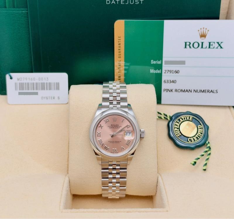 Rolex Ladies Datejust 279160 28mm Pink Roman Dial Stainless Steel Box Paper: Condition: Pre-owned - Excellent,Bezel Color: Silver,Indices: Roman Numerals,Year Manufactured: 2010-2019,Band/Strap: Rolex Jubilee,Case Color: Silver,Department: Women,Bezel Type: Smooth,Watch