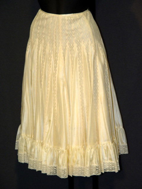 NEW DKNY SKIRT: BEIGE COTTON/SILK BLEND OUTER LAY: NEW DKNY SKIRT: BEIGE COTTON/SILK BLEND OUTER LAYER, NYLON SECOND AND THIRD LAYER, AND ACETATE INNER LAYER WITH SIDE ZIPPER. SIZE 14. RETAIL PRICE $348.00. SALES TAG ATTACHED.