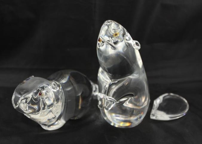 Two Steuben glass beavers one in perched position: Two Steuben glass beavers one in perched position with broken tail 6.5"T, other in natural position 9.5"L, both marked "Steuben" in boxes.