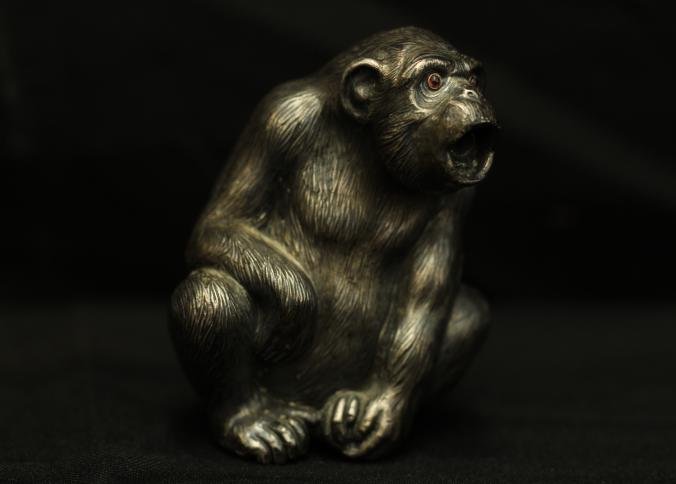 Silver monkey with intricate workmanship and detail: Silver monkey with intricate workmanship and detail, precious stones as eyes believed to be ruby, has all the characteristics of a Faberge piece but has no visible markings 2.75"T.