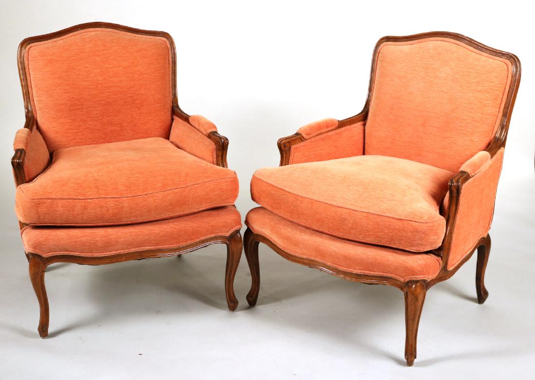 Pair of Louis XV Style Mahogany Bergeres: French Taste, 20th C., with coral upholstery. 35-1/2" x 29"w x 24"d