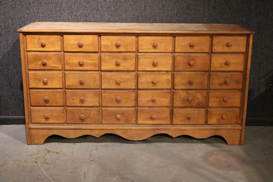 Maple Apothecary Long Cabinet: Fitted with rows of short drawers. 40"h x 6'4"w x 20"d Provenance: Property Sold for the Benefit of Greenwood Gardens, Short Hills, NJ.