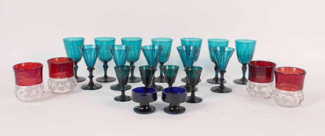 Assorted Glass Stemware and Tumbler Glasses: Including eleven green glass wine glasses, four green glass cordial glasses, four cranberry pressed to clear glass tumblers and two cobalt glass salt cellars. Wine glass 5"h