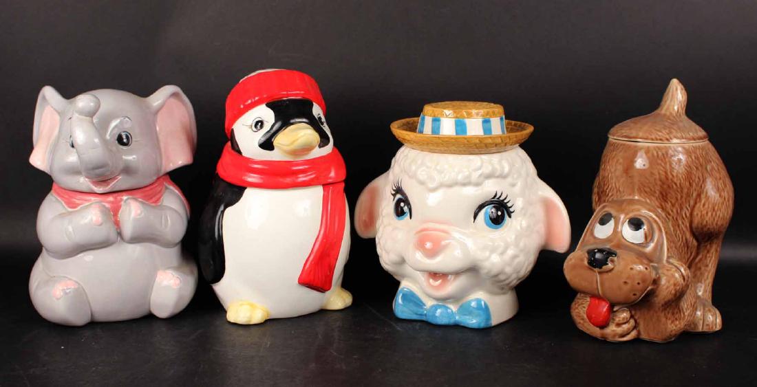 FOUR COOKIE JARS: Depicting a Penguin, Elephant, Dog and Sheep with Hat. Tallest 11"h Provenance: Property of a New Jersey Collector.