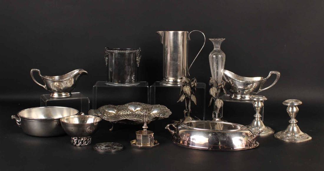 GROUP OF SILVER PLATED TABLE ARTICLES: Comprising, a Puiforcat wine coaster, a Hermes style bowl, two sauce boats monogrammed R.E., an entree dish cover, a tankard, a Christofle two handled vegetable bowl, and Naylor Brothers English Silve