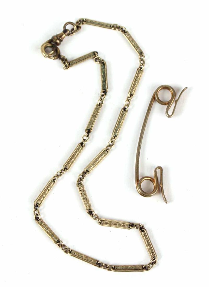 GOLD FILLED WATCH CHAIN: Together with a gold tone tie bar. Chain, 13"l Property from the Collection of Dr. Arthur and Hope S. Miller.