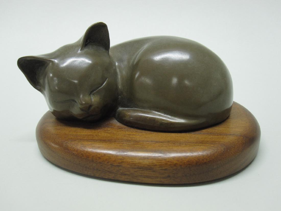 BRONZE FIGURE OF SLEEPING KITTEN: By Wah Chang mounted on wooden base. 5 1/2"long x 4" wide and 2 1/2" tall
