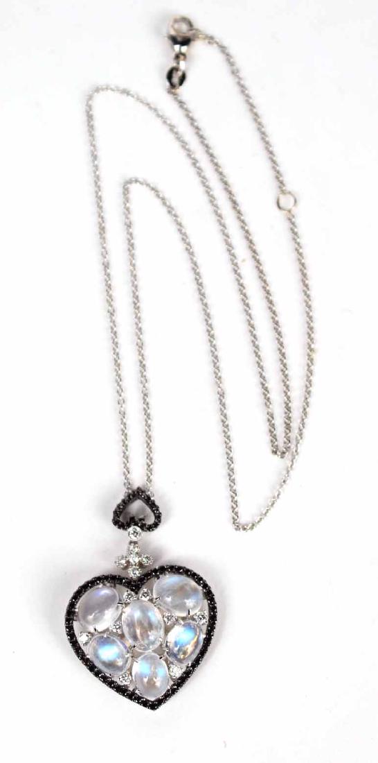 18K White Gold Moonstone Diamond: Pendant, heart form, containing six facet set oval moonstones, seven small round prong set white diamonds, each weighing approx. approx. .10carats, within heart form frame set with small round prong s