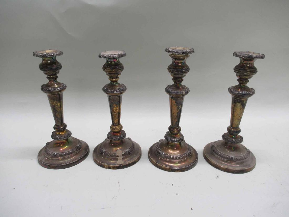 FOUR WEIGHTED SILVER PLATED CANDLESTICKS (1 of 4)