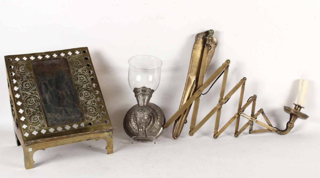 Pierced Brass Book Rest: Probably English, 19th/20th C. Together with a white-metal elephant-form wall sconce and a brass extending wall sconce. 3 pieces Book Rest: 14"h x 12-1/4"w x 11-1/4"d Property from the Collection of P