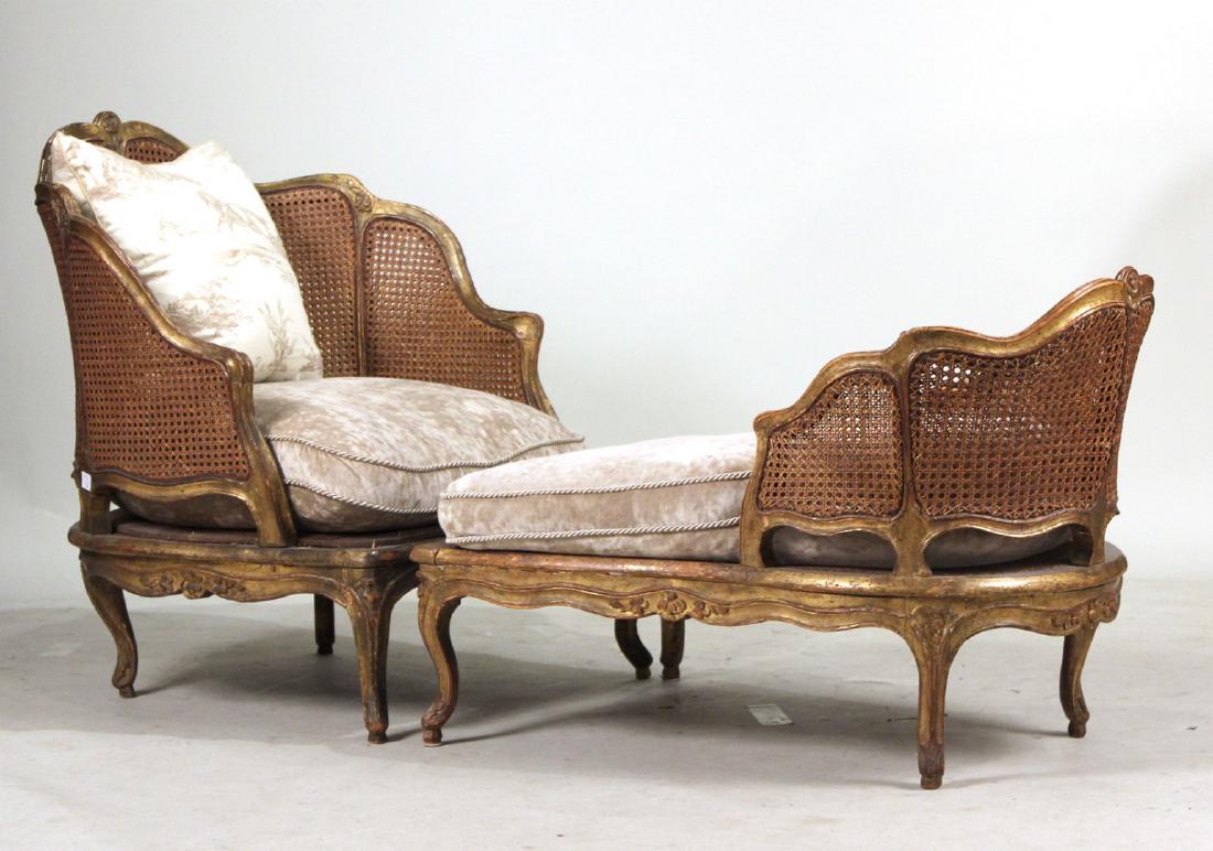 Louis XV Style Caned Duchesse Brisee: In two parts and gold painted. Including two cream cushions. 37"h x 32"w x 73"d Collection of the late Judith Leiber.