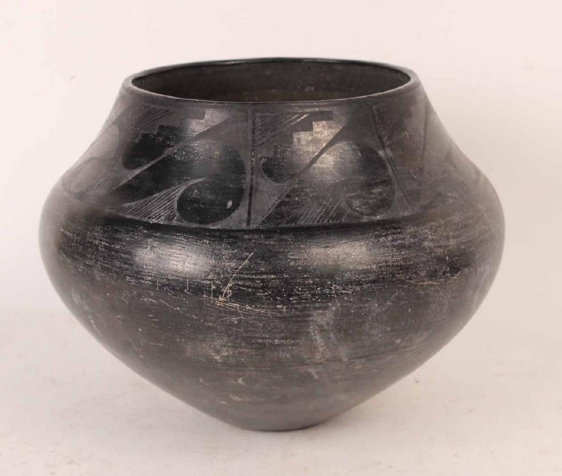 Black on Black Olla or Storage Jar: Possibly Santa Clara. Period faded label pasted on side. 10"h x 12"dia. By descent from the Estate of Robert Weeks DeForest and Emily Johnson DeForest