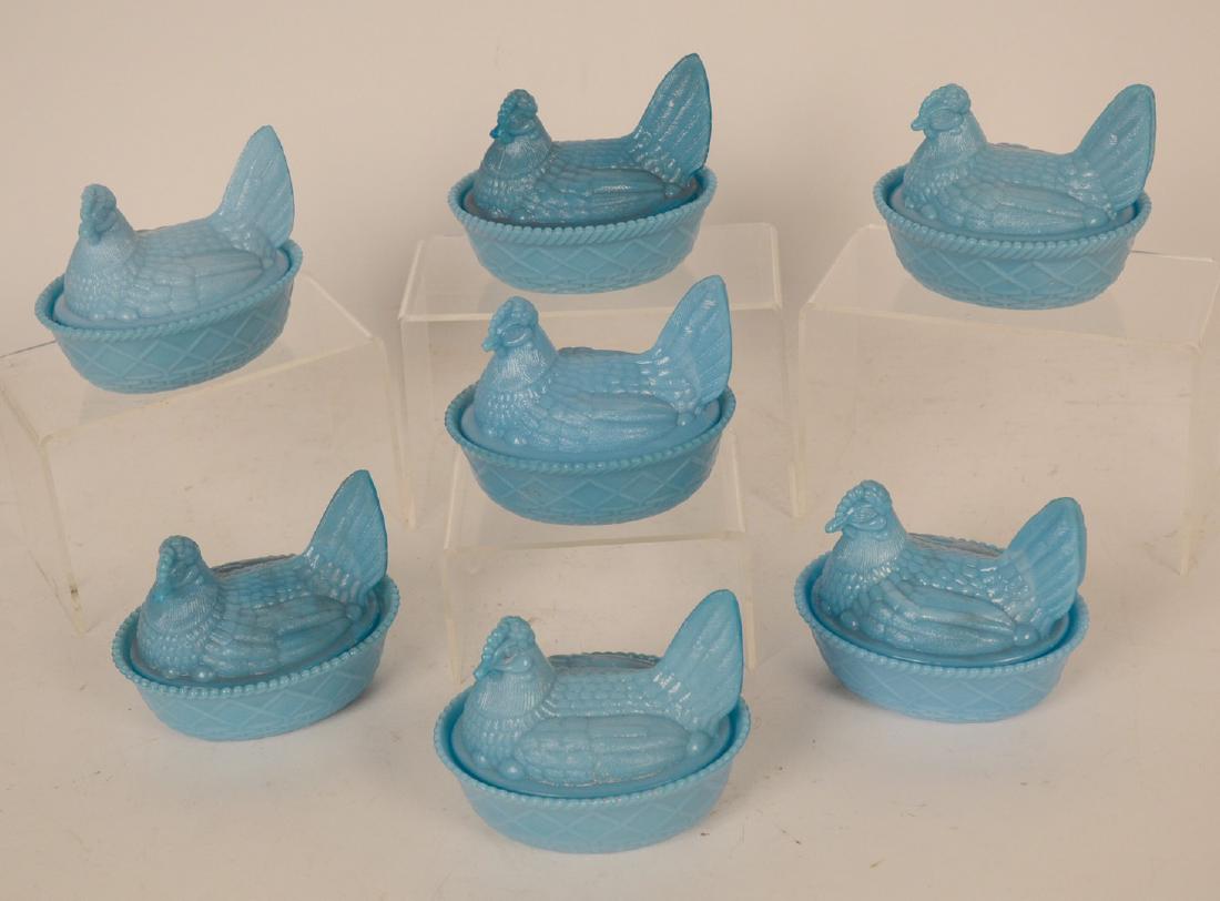 Seven Blue Milk Glass Hen on Nest Covered Dishes: 4 1/2"h x 5"l By descent from the Estate of Robert Weeks DeForest and Emily Johnston DeForest.