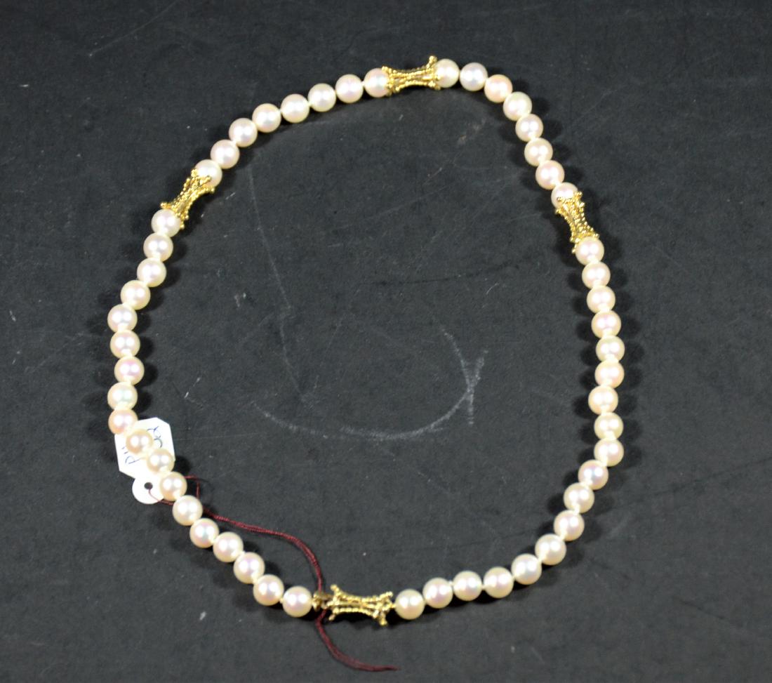Cultured Pearl 18K Yellow Gold Necklace: 6.5-7MM pearls with 18K yellow gold rondels and clasp. 17"l. From The Personal Property of Claus & Irma Vollrath.