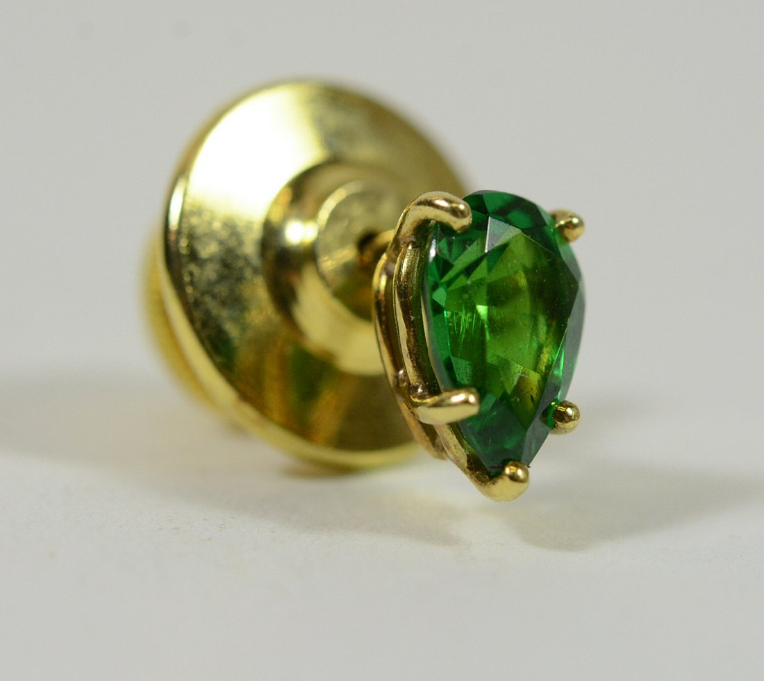 18K yellow Gold Tsavorite Tie Pin: Prong set pear shaped tsavorite, weighing approx. .24carat. Approx. 1/4"l. From Claus Vollrath Inc., Mt. Kisco, New York.