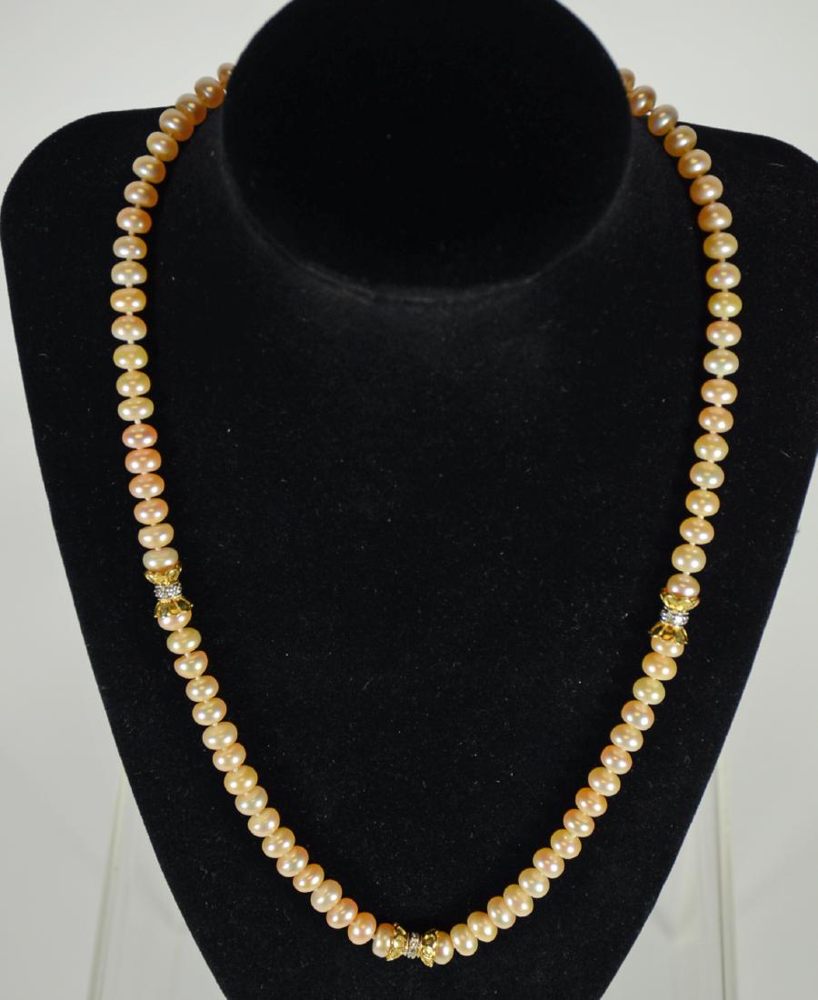 18K Yellow Gold Pink Freshwater Pearl: With diamond necklace, clasp 18K yellow gold with 14K yellow gold tonque, three 18K yellow gold stations, each center diamond bead set. 19.75"l. From Claus Vollrath Inc., Mt. Kisco, New York.