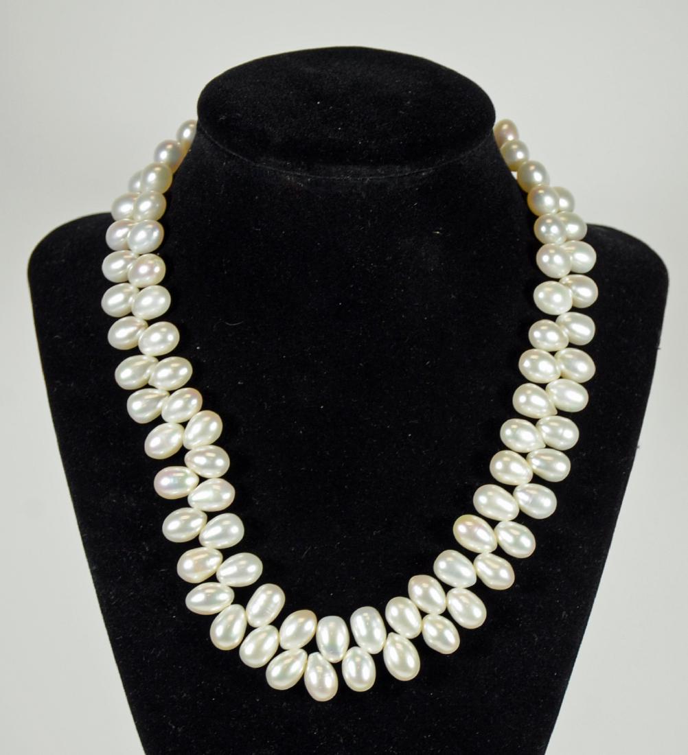 White Freshwater Drop Pearl Necklace: With 18K white gold clasp. 17.5"l. From Claus Vollrath Inc., Mt. Kisco, New York.