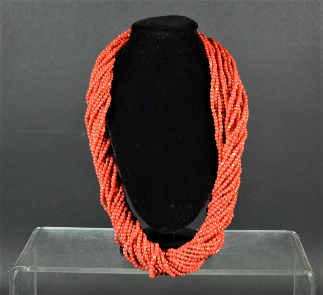 Twenty Strand Coral Beaded Necklace: With 18K yellow gold clasp and gold faceted beads. 19"l. From Claus Vollrath Inc., Mt. Kisco, New York.