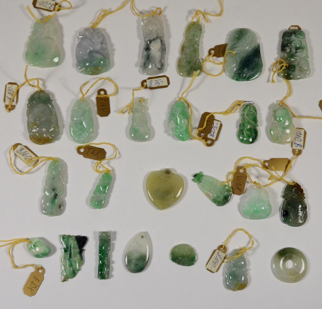 Twenty Two Carved & Polished Jade Pendants: Tones of green, together with three jade fragments. Ranging from 3/4"h x 1/2"w to 1-1/2"h x 1-1/4"w. From Claus Vollrath Inc., Mt. Kisco, New York.