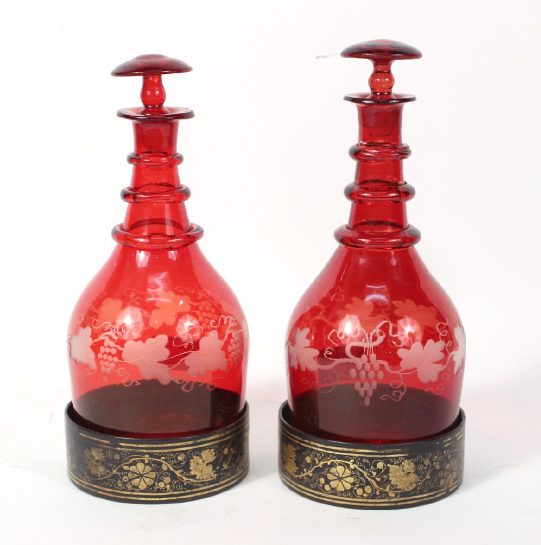 Pair of Ruby Cut-to-clear Decanters: Together with a pair of papier mache coasters, 19th c. 11"h