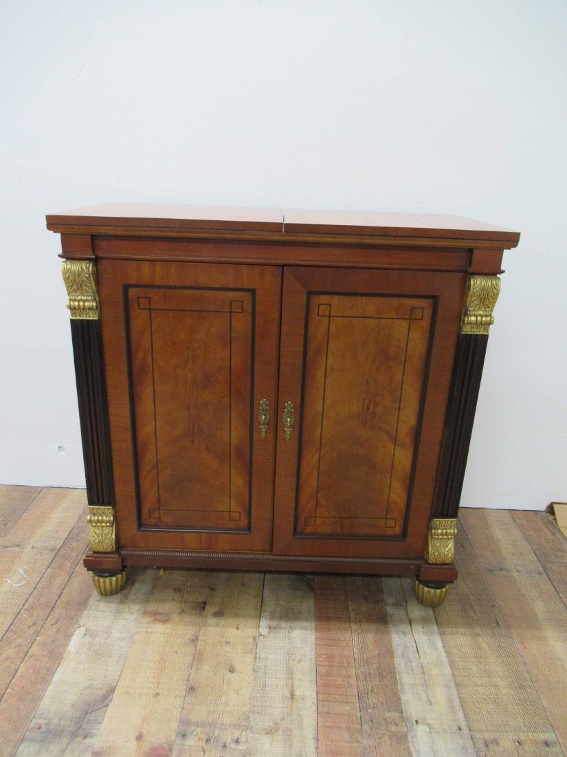 Baker Mahogany serving cabinet: Fold out top above two ebony inlaid blind doors flanked by guilt decorated columns. 33 1/2 tall x 34" wide x 16" deep, open top size 60" long