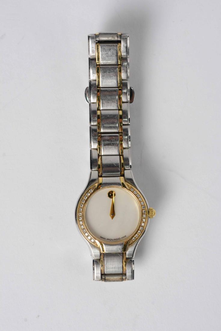 Movado Stainless & Diamond Ladies Quartz: Wristwatch, containing 28 round full cut diamonds, weight approx. .28ct., Color: G-H, Clarity: VS, circular mother-of-pearl dial, gold dot at 12, #5162898, 81E41841S. Dial, 7/8"d., length approx. 7-1/