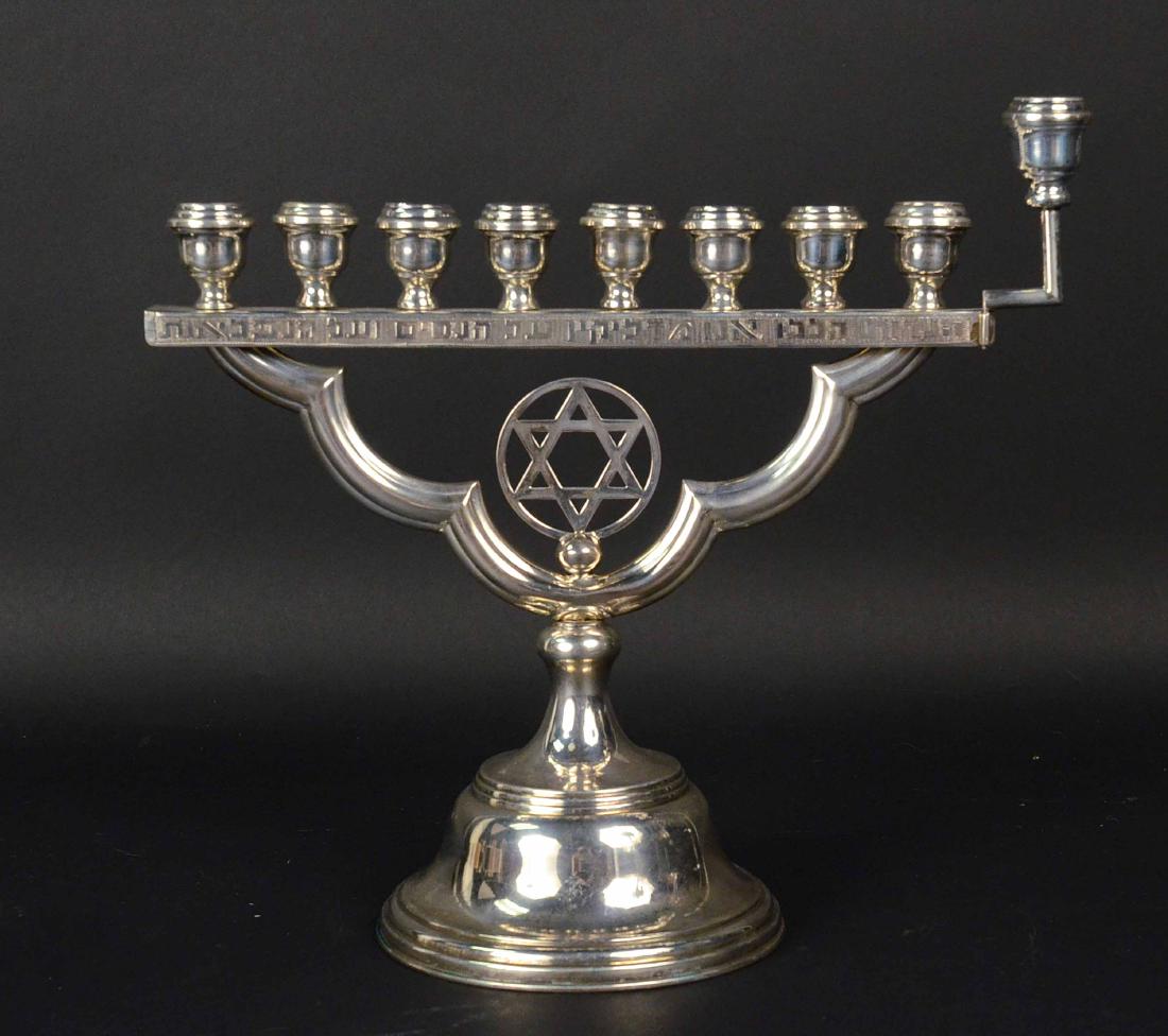 Sterling Silver Menorah: With center Star of David on circular base, weight approx. 14 T.O. 11-3/4"h x 10-3/4"w.