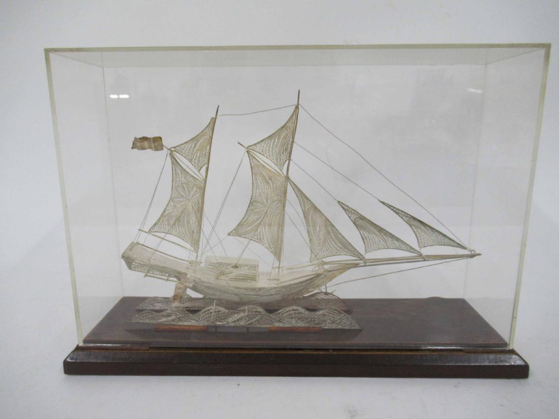 Unmarked Silver Filigree Schooner: Together with a lucite display case.